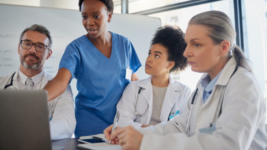teamwork, healthcare and planning with a doctor, nurse and medicine team at work on a laptop during a meeting. collaboration, research and insurance with a medical group working in the hospital