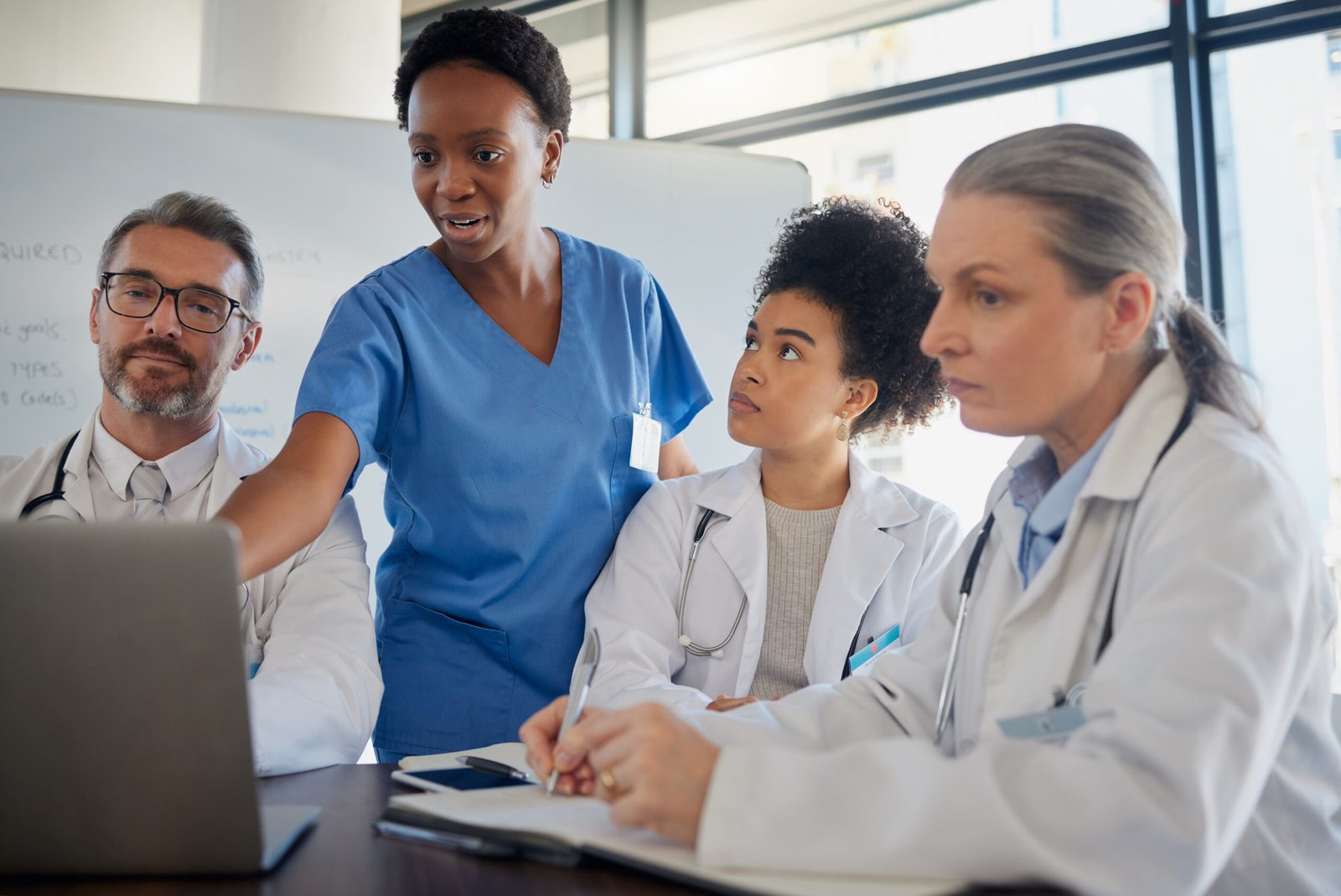 Teamwork, healthcare and medicine with a doctor, nurse and medicine team at work on a laptop during a meeting. Collaboration, research and insurance with a medical group working in the hospital