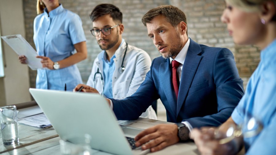 businessman and group of doctors using laptop during the meeting.